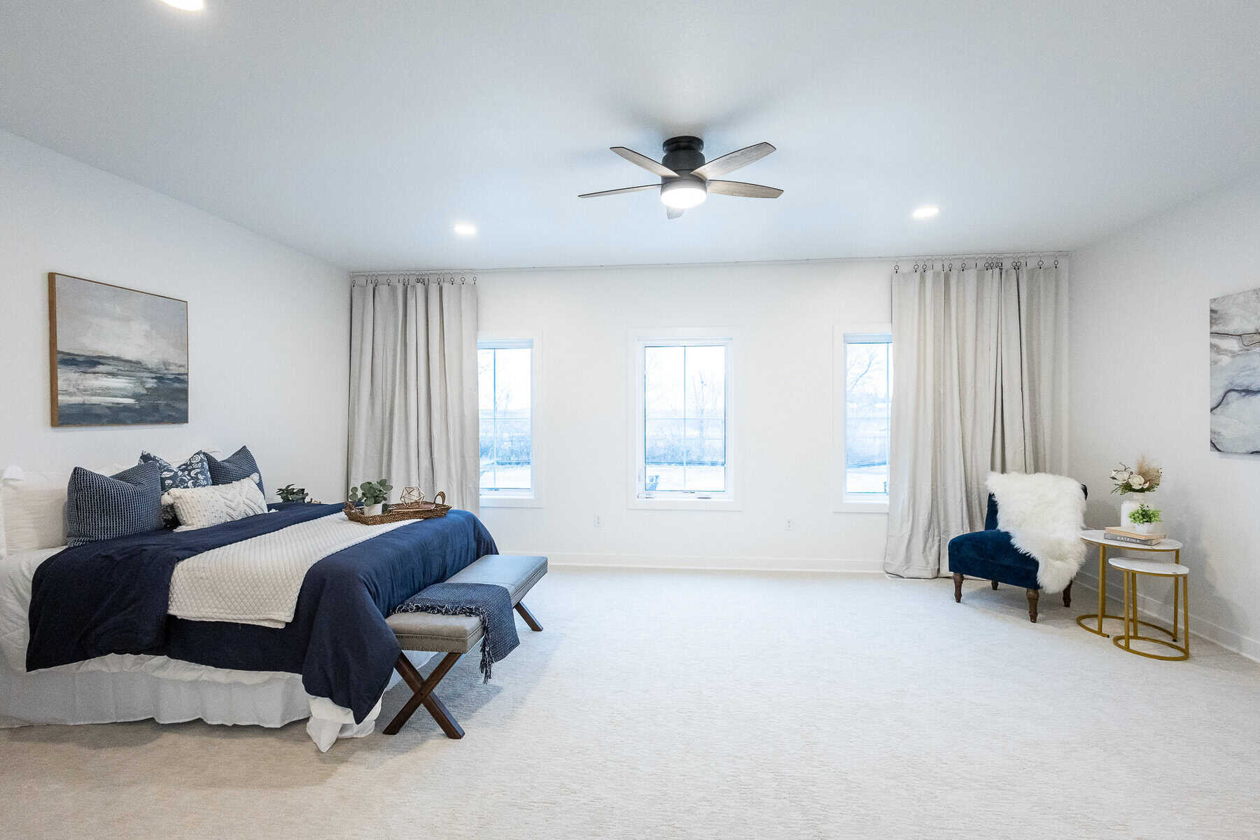 Large primary bedroom with three windows