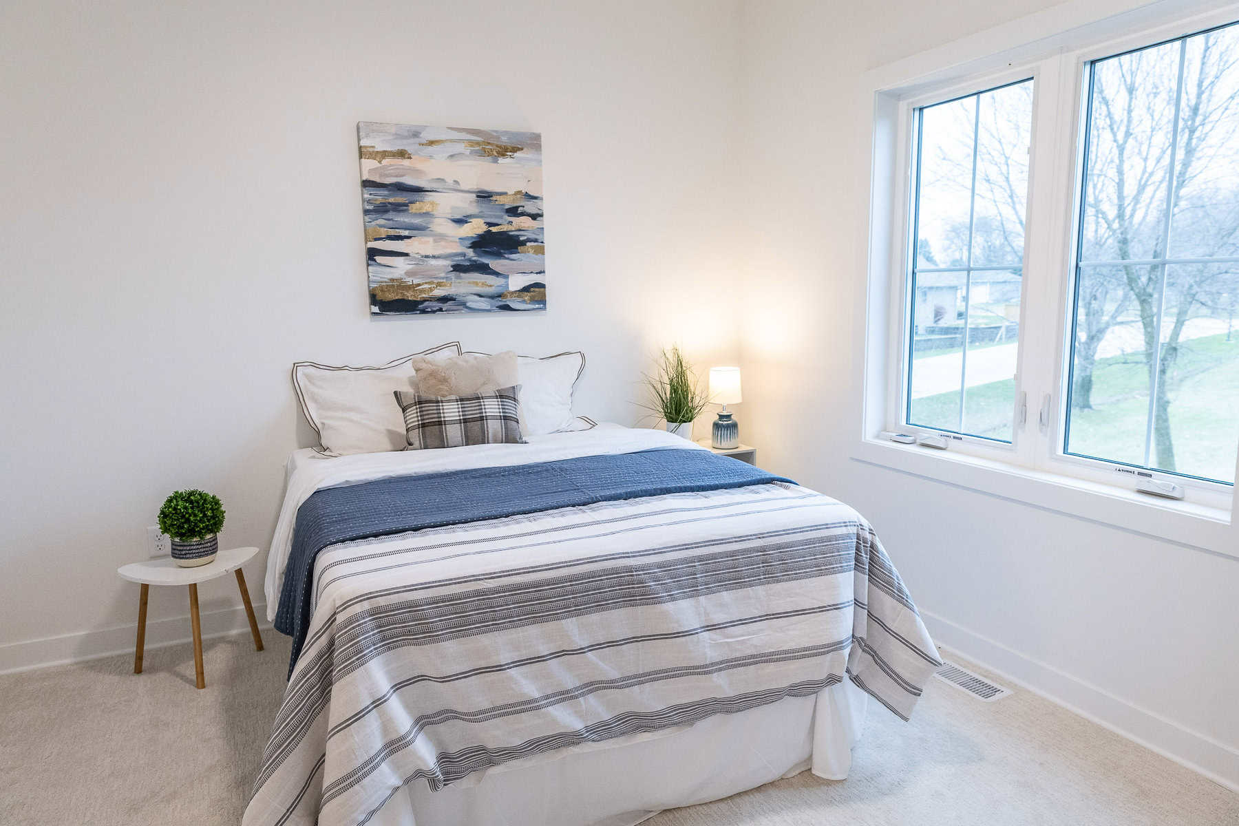 Guest bedroom with blue and white bedding